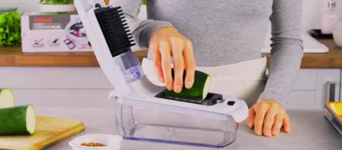 Vegetable Chopper being used to slice zucchini in a modern kitchen.