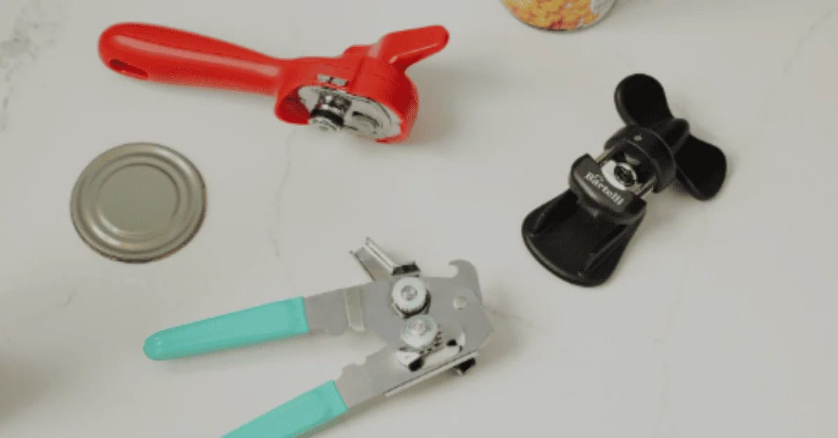 Can Openers tools laid out on a white countertop, including manual crank, butterfly-style, and ergonomic handle designs.
