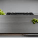 Titanium Cutting Board with knife and fresh vegetables in a modern kitchen setting