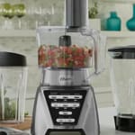 Blenders with multiple jars and fresh ingredients on a modern kitchen counter