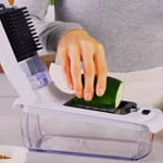 Vegetable Chopper being used to slice zucchini in a modern kitchen.