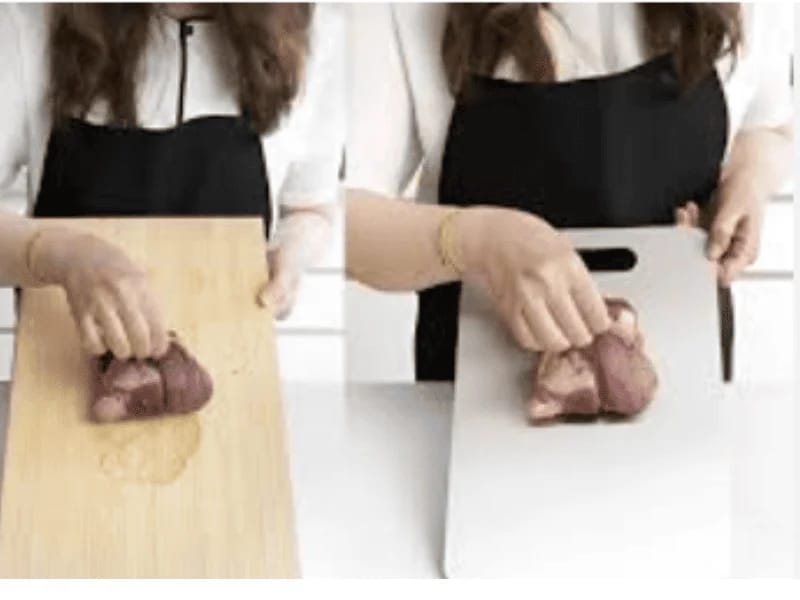 Titanium Cutting Board compared with a wooden board while handling raw meat.