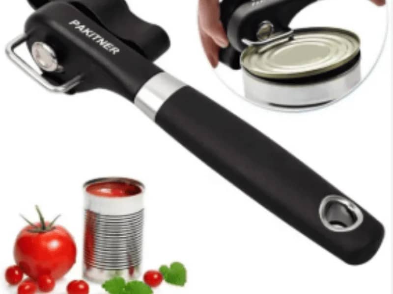 Can Opener in action being used to open a can of tomato sauce with a black ergonomic handle